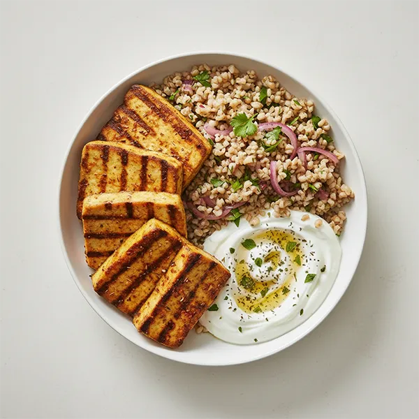 Middle eastern spiced grilled tofu with onion herbed bulgur and garlic yogurt dip